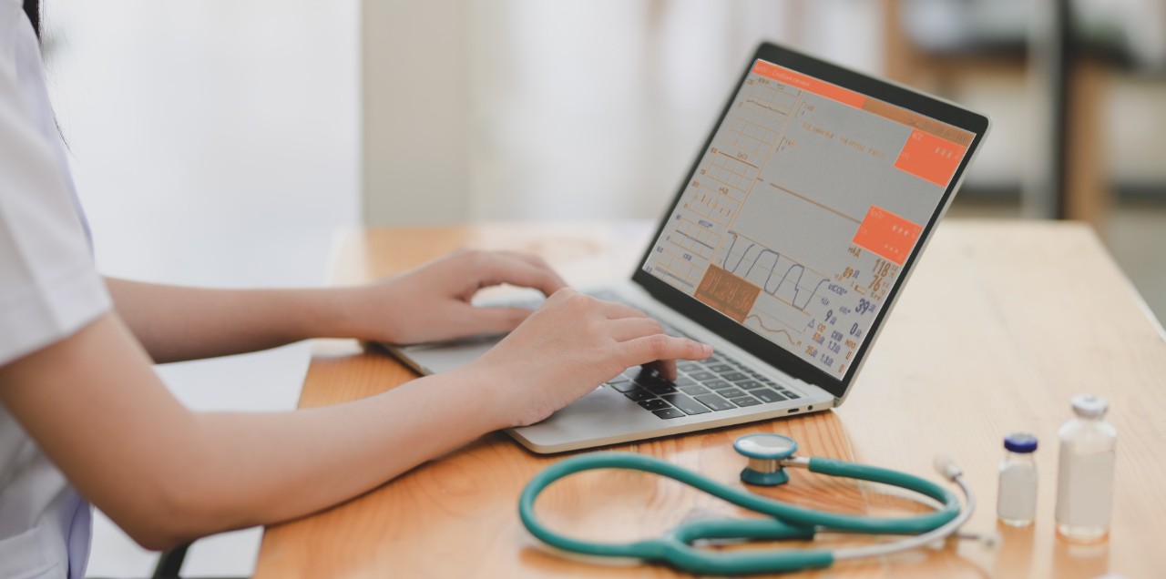doctor is writing down a patient history into the computer